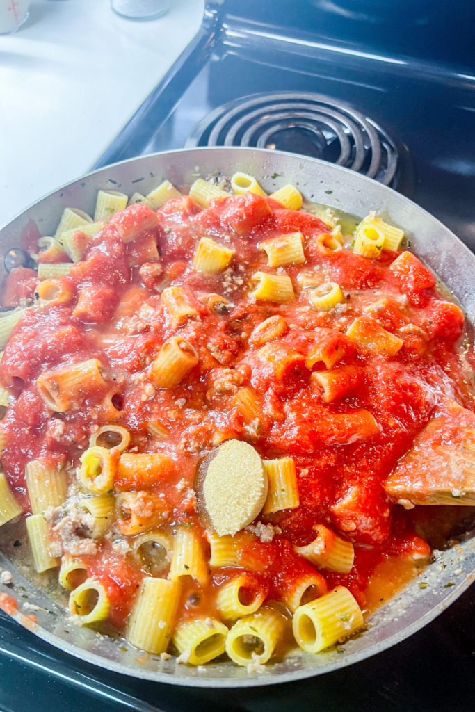 One-Pot Rigatoni Ragu adding tomatoes, sugar and fish sauce