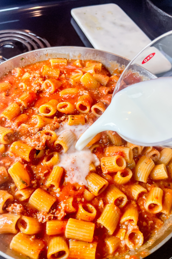 One-Pot Rigatoni Ragu - pouring in milk