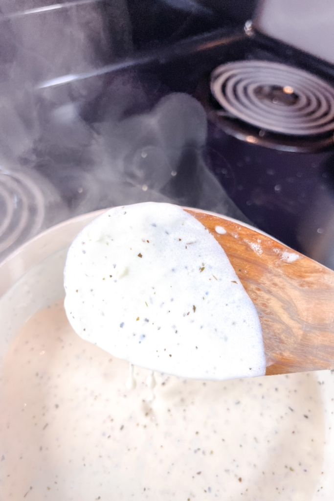 finished sauce on a wood spoon