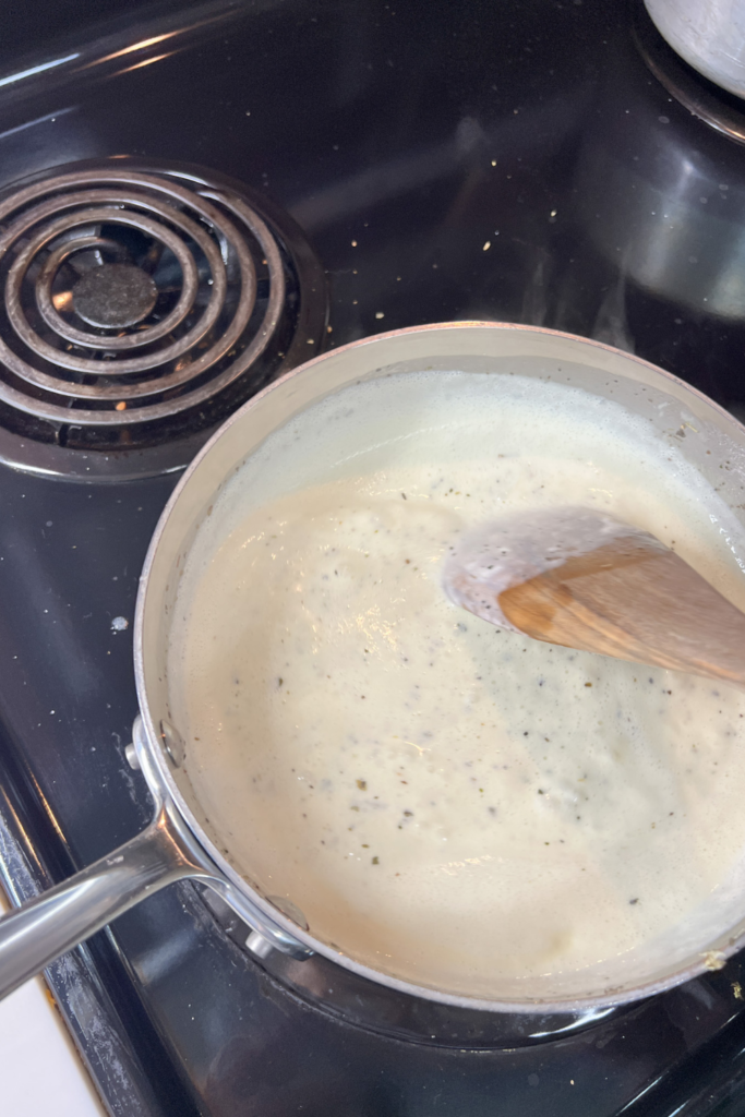 stirring alfredo sauce