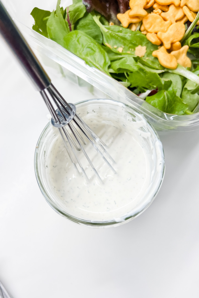 finished ranch dressing with a whisk