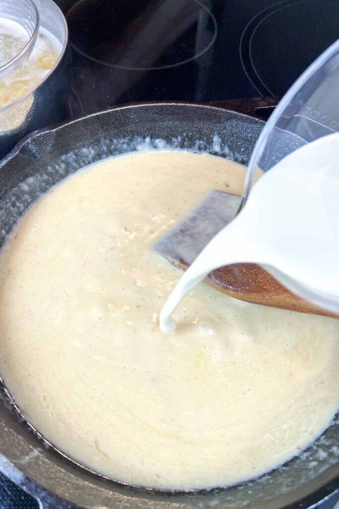 milk being added to the cheese sauce
