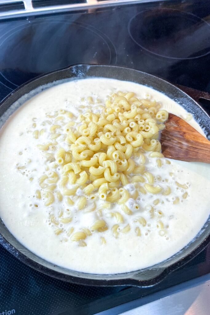 all of the macaroni added to the cheese sauce.