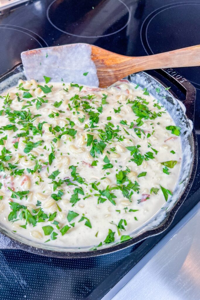 parsley added on top of the finished mac and cheese dish.
