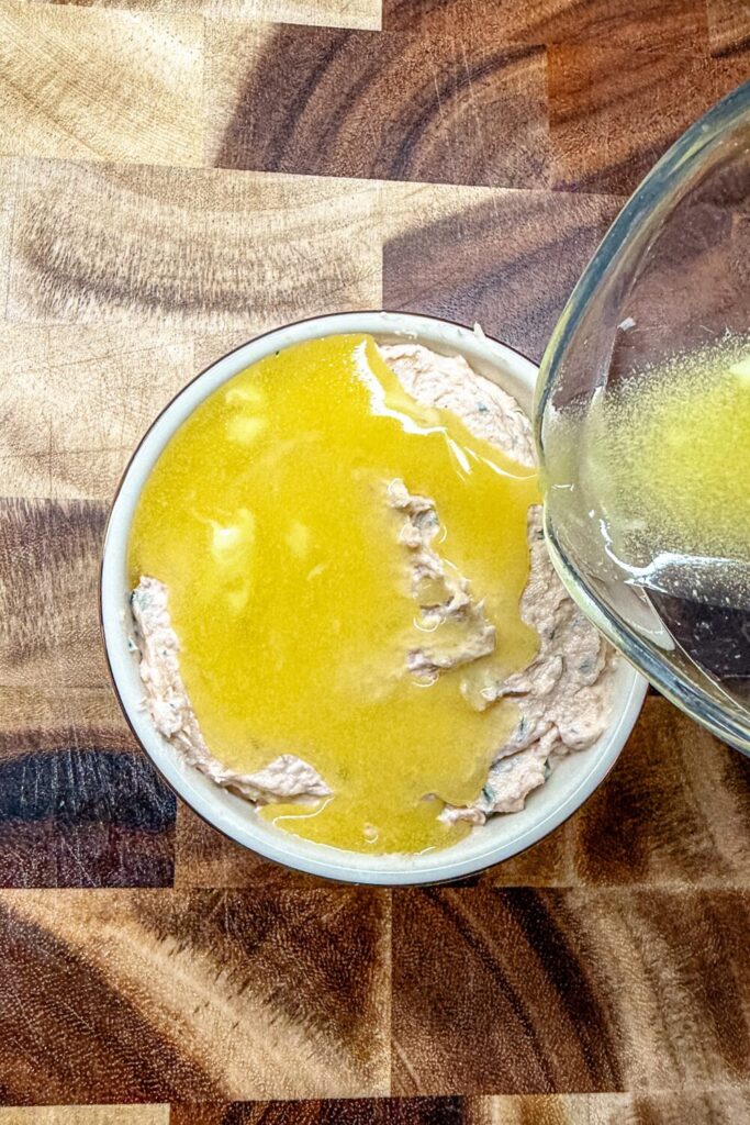 melted butter going over Salmon Rillette