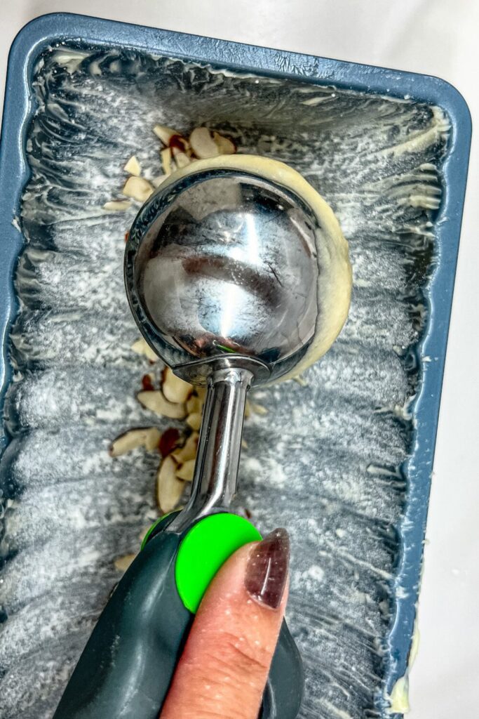 a cookie scoop dropping batter