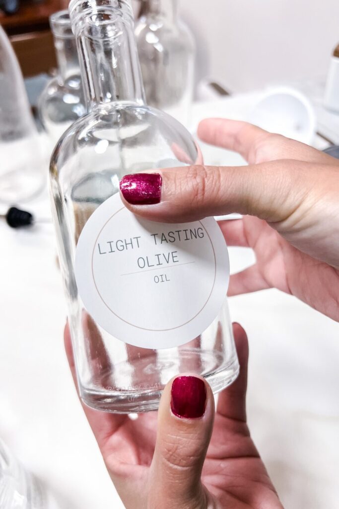 a person holding a bottle gently rubbing the label on to the bottle (2)