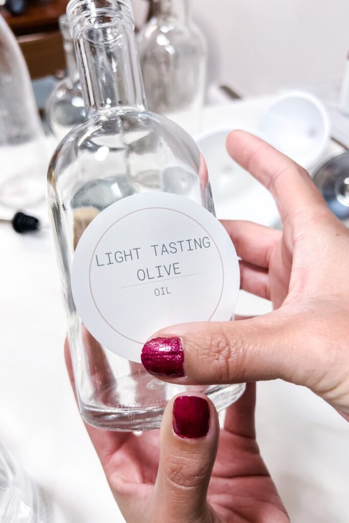 a person holding a bottle gently rubbing the label on to the bottle