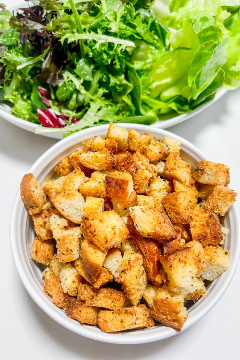 a bowl of croutons and a salad next to each other