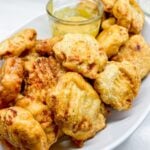 finished nuggets on a platter with honey mustard sauce