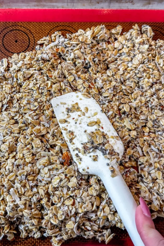 Homemade Granola being spread with a spatula