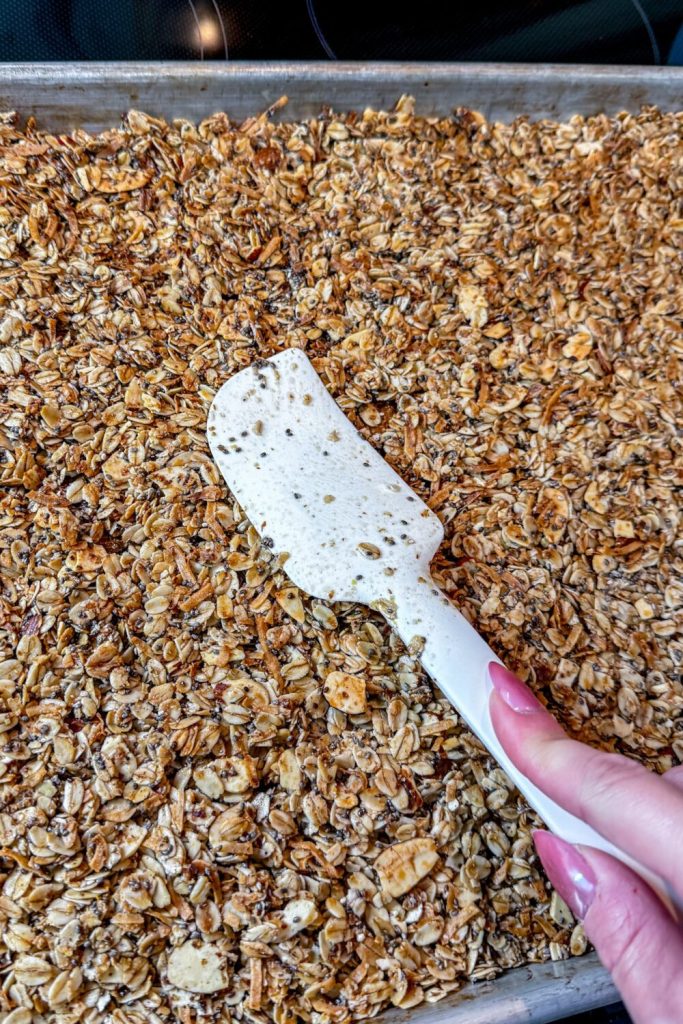 Homemade Granola pressing freshly baked pans