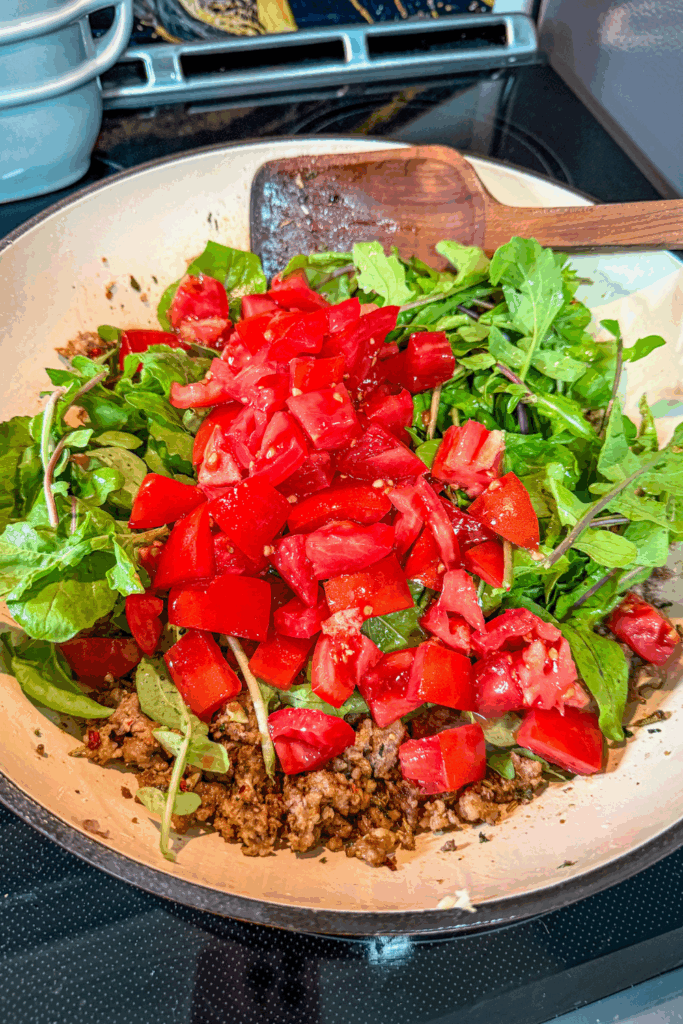 adding veg to the sauasage mixture