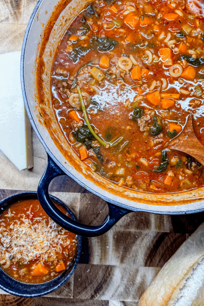 Italian Ground Sausage Soup in a dutch oven and bowl