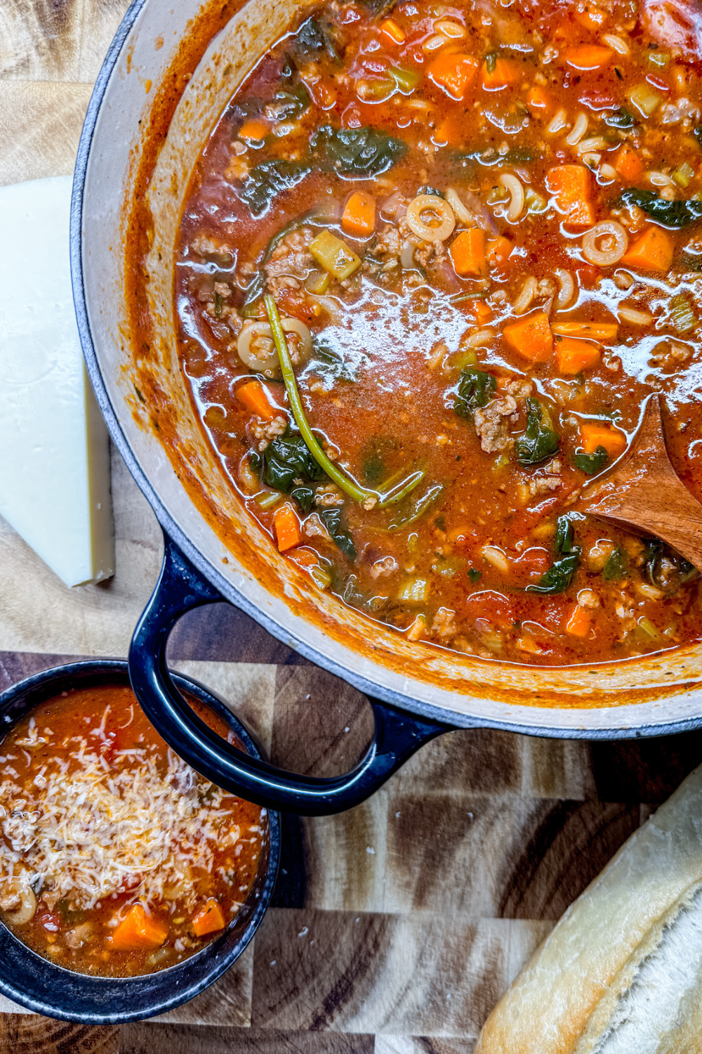 Italian Ground Sausage Soup in a dutch oven and bowl