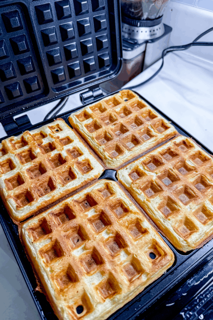 a waffle iron with four waffles on it
