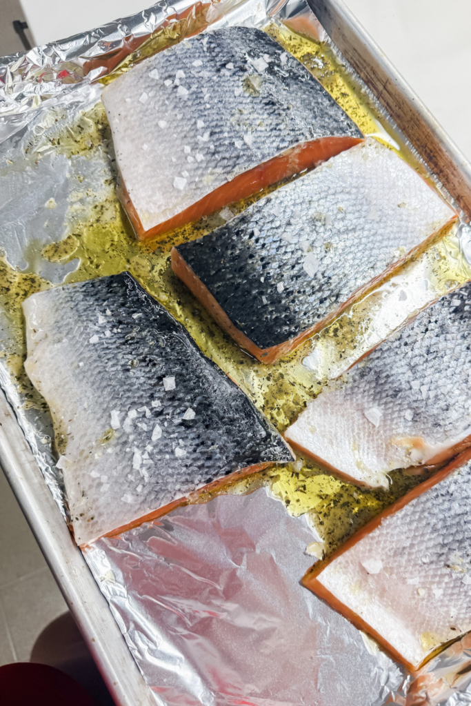 Salmon flipped skin-side up on baking sheet before going into the oven