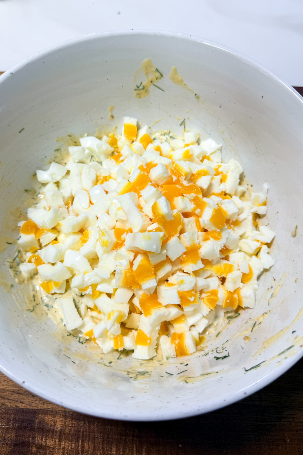 Chopped eggs added to creamy herb dressing for egg salad