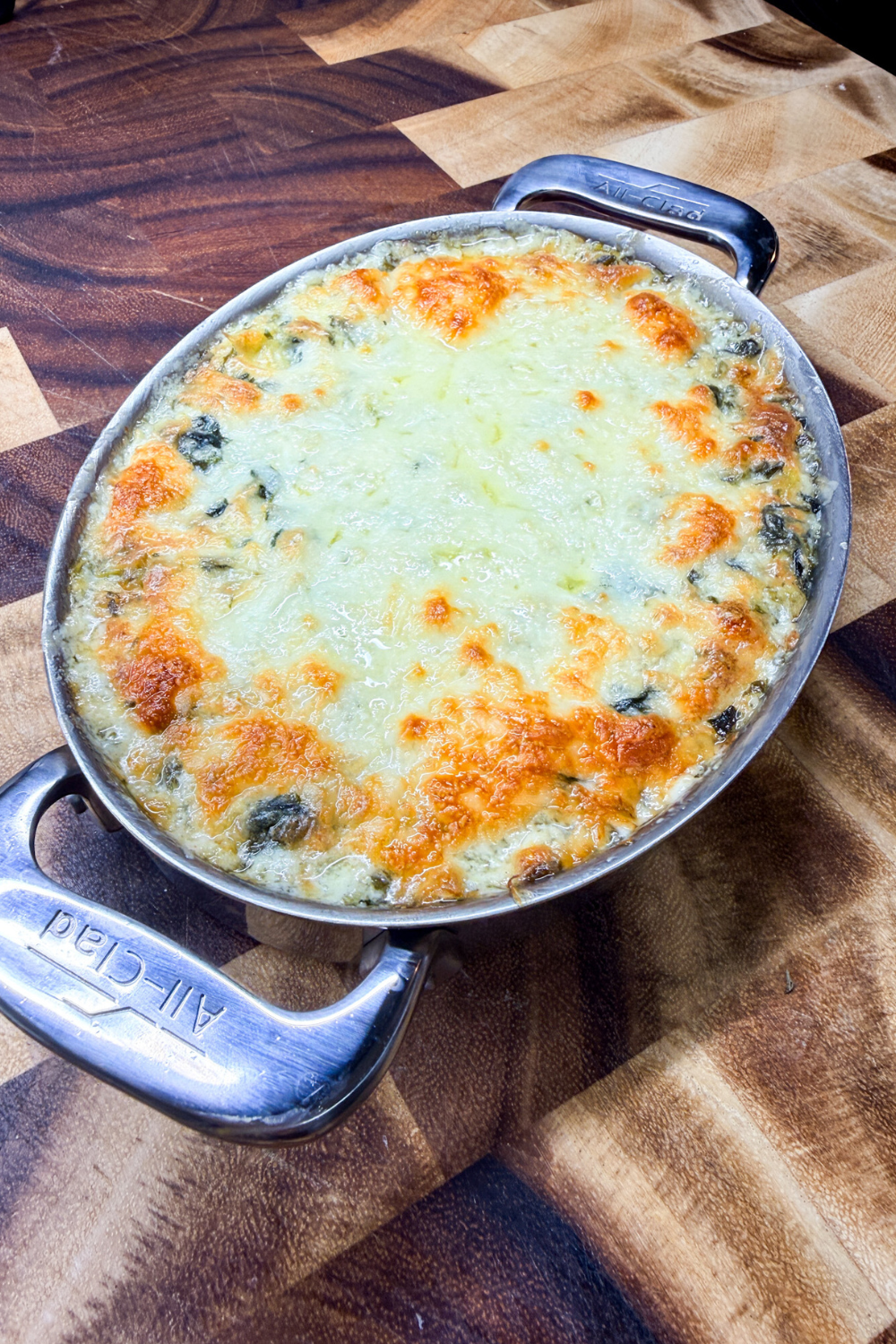 Hot spinach artichoke dip baked until bubbly with a golden melted cheese topping.