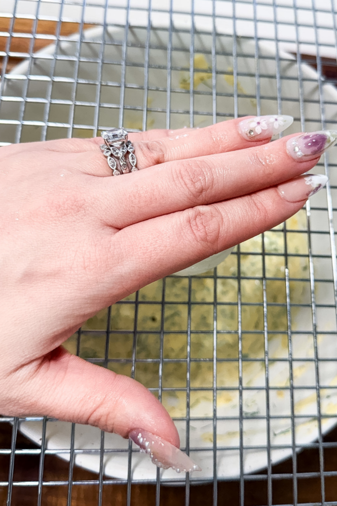 Chopping hard boiled eggs using a cooling rack over a bowl