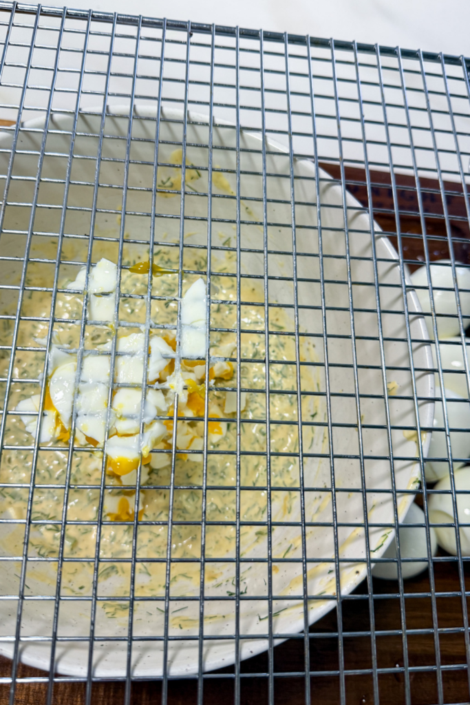 Hard boiled eggs pushed through rack for easy chopping