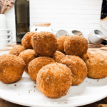 Crispy leftover ham croquettes piled on a plate with a golden breadcrumb crust