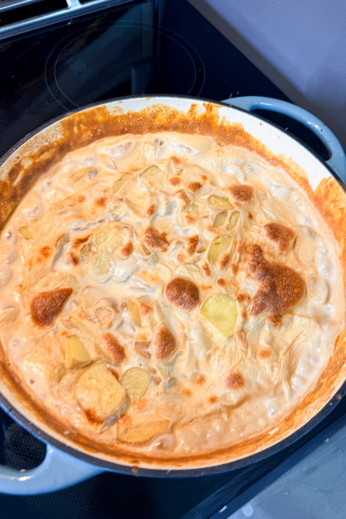 partially baked potatoes au gratin with lightly browned edges