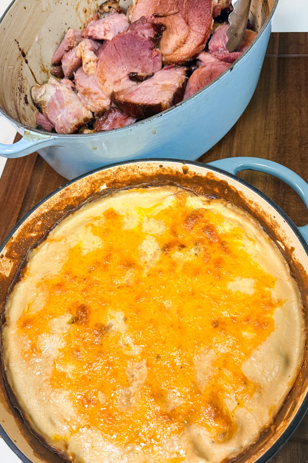 cheesy potatoes au gratin served with baked ham for holiday dinner