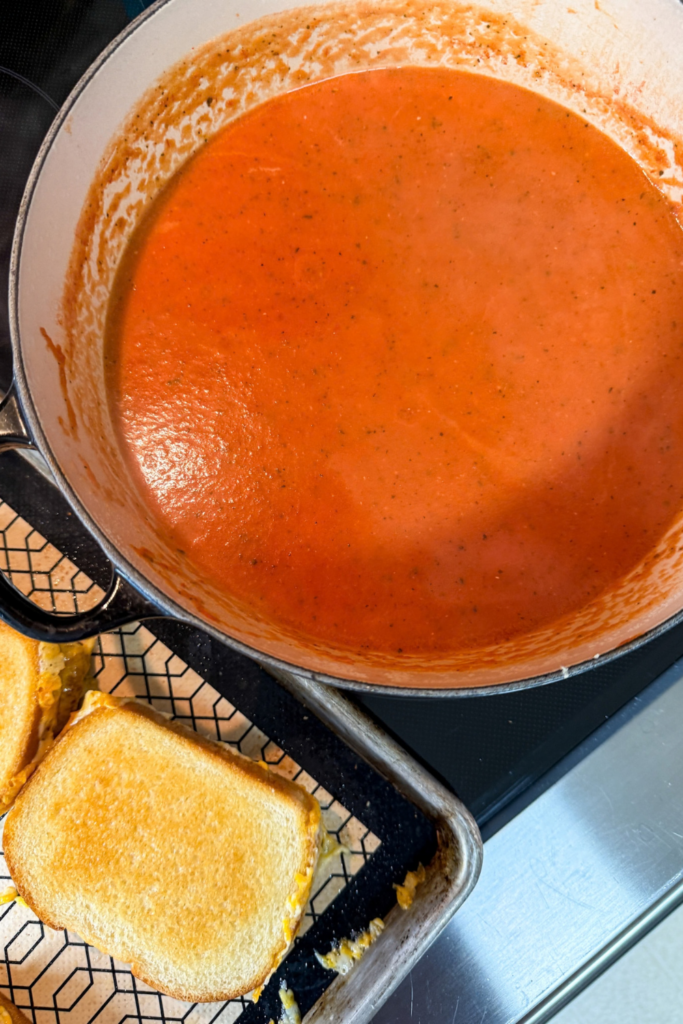 Smooth creamy tomato soup after blending in Dutch oven