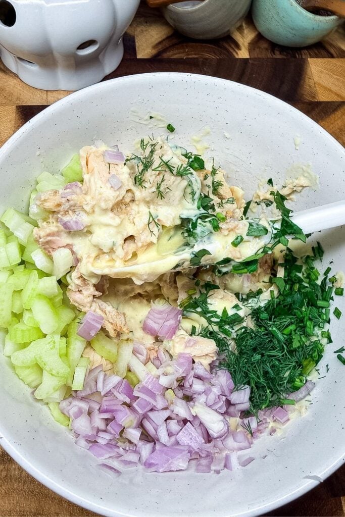 Homemade mayonnaise added to tuna and vegetables before mixing