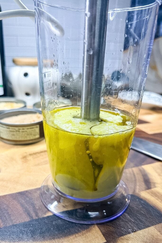 Immersion blender starting to emulsify oil and egg into homemade mayonnaise