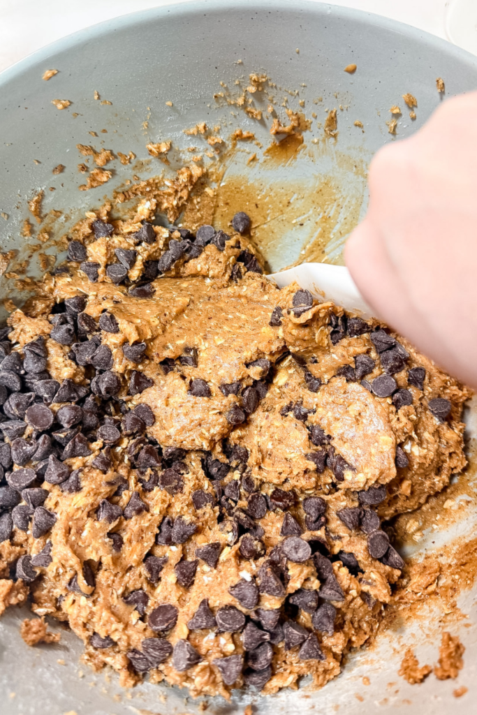 Mixing peanut butter oatmeal cookie dough with chocolate chips