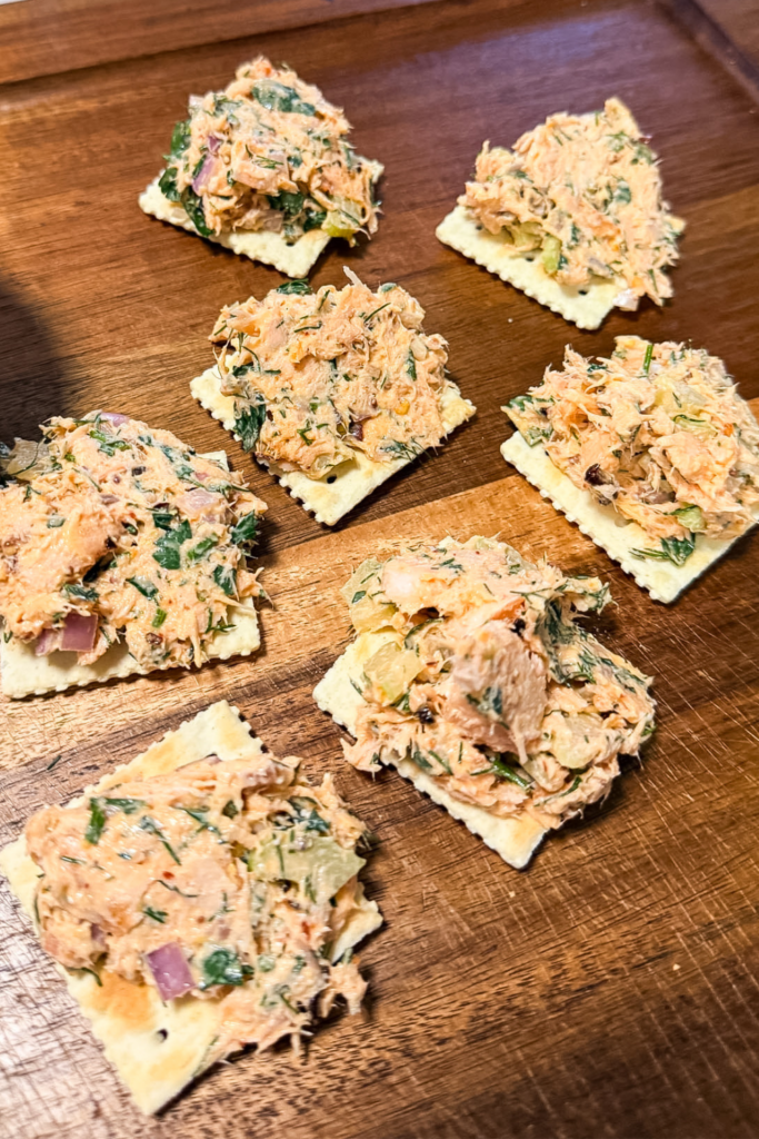 Salmon salad served on crackers for an easy appetizer