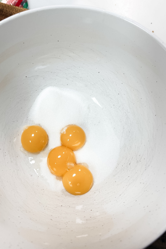 Egg yolks and sugar in a bowl for making tiramisu mascarpone base