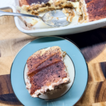 Close-up of a classic tiramisu slice showing layers of espresso-soaked ladyfingers and mascarpone cream