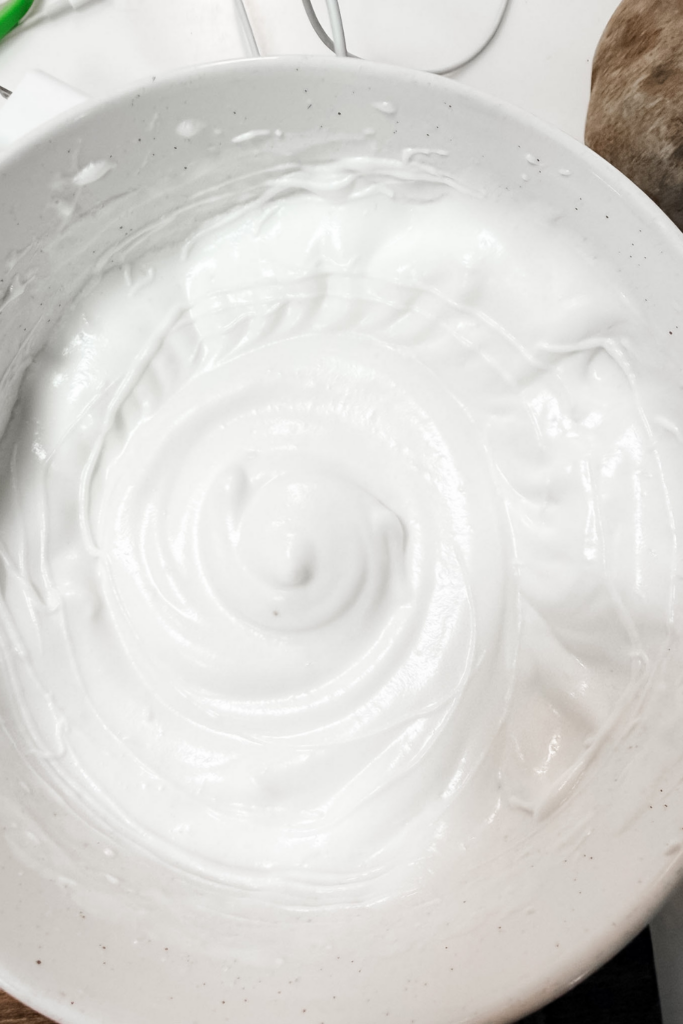 Whipped egg whites at stiff peaks for light and airy tiramisu cream