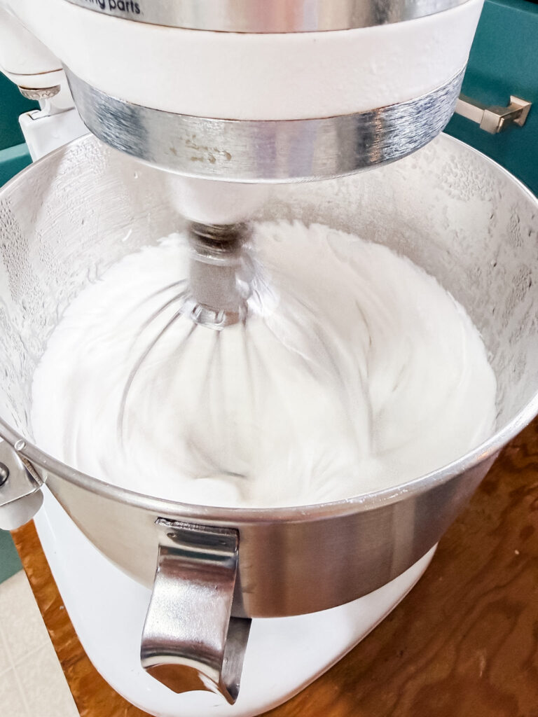 KitchenAid stand mixer bowl full of thick, fluffy, brilliantly white marshmallow mixture after 12 minutes of beating
